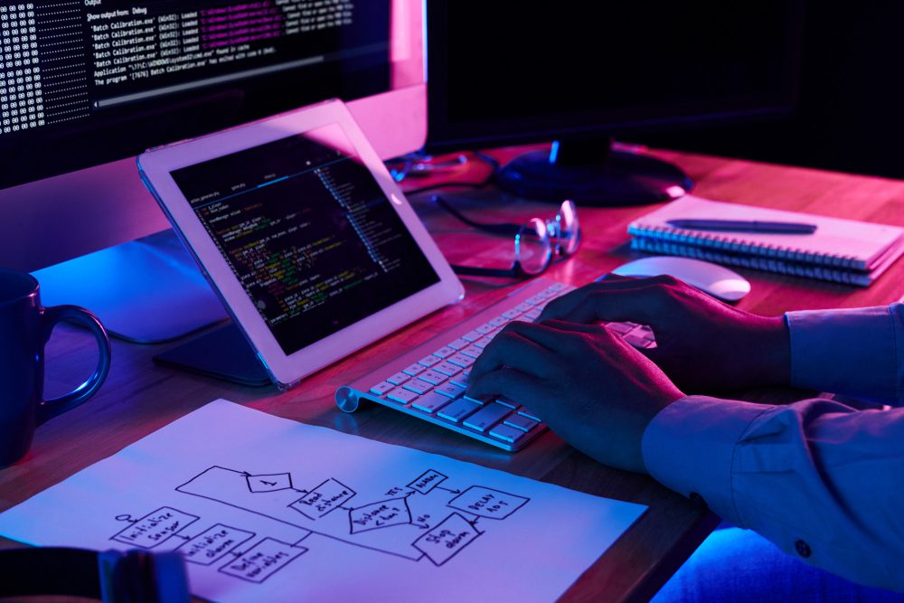 Close Up Image Of Programer Working At His Desk In Office